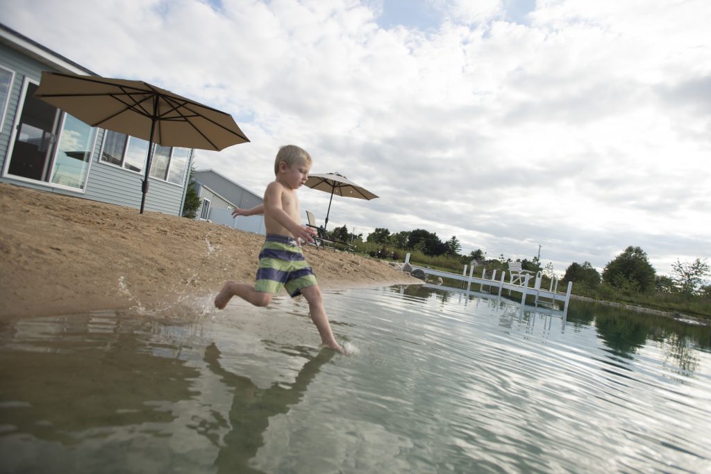 Backyard swim pond fun begins in the water