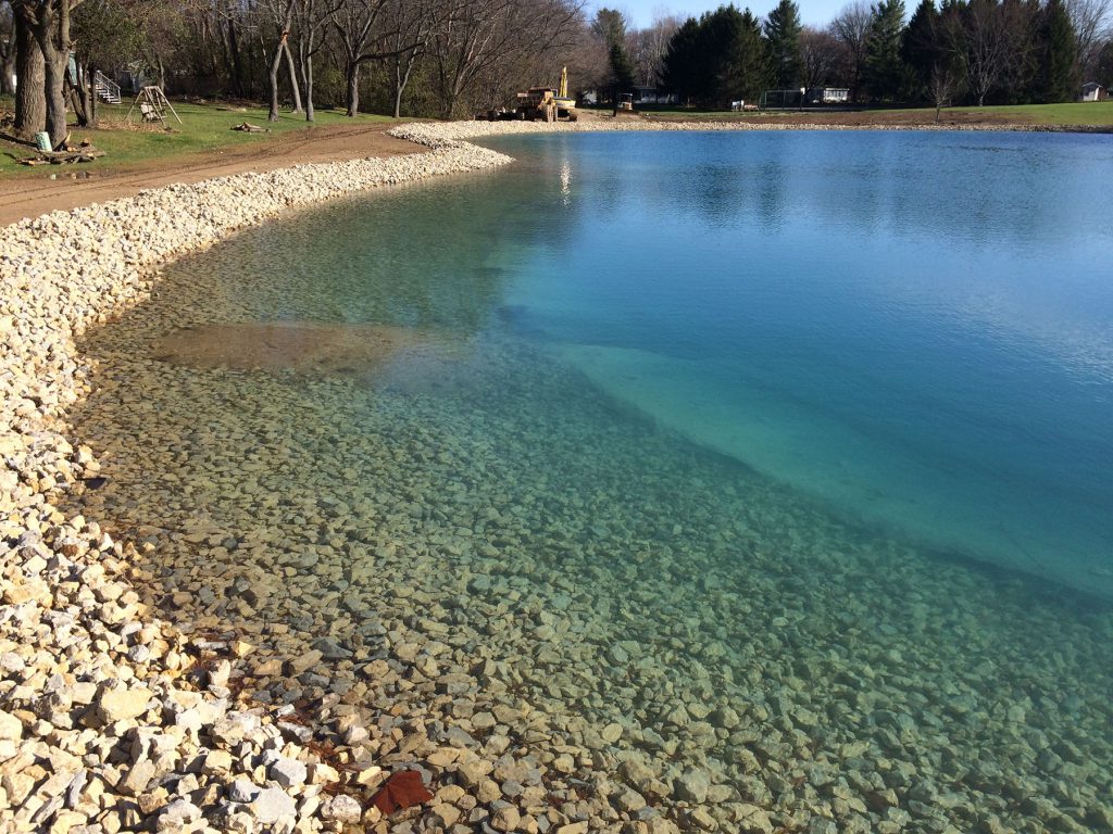 stone riprap, clear pond