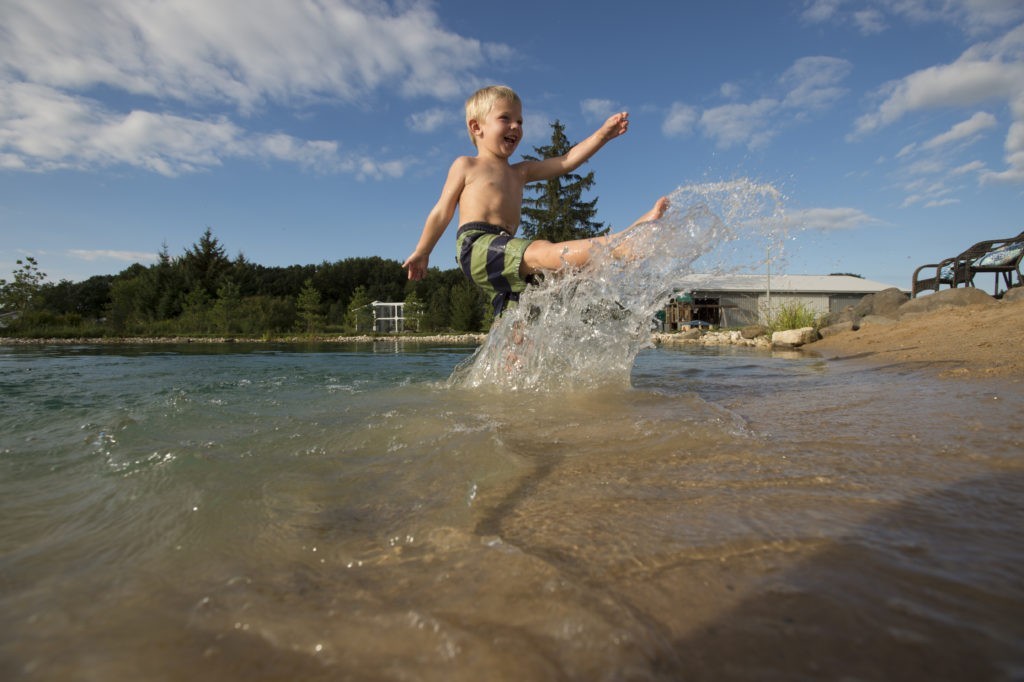 Backyard swim pond water splashing and playing