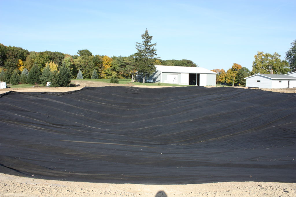 Backyard swim pond underlayment liner installation completion