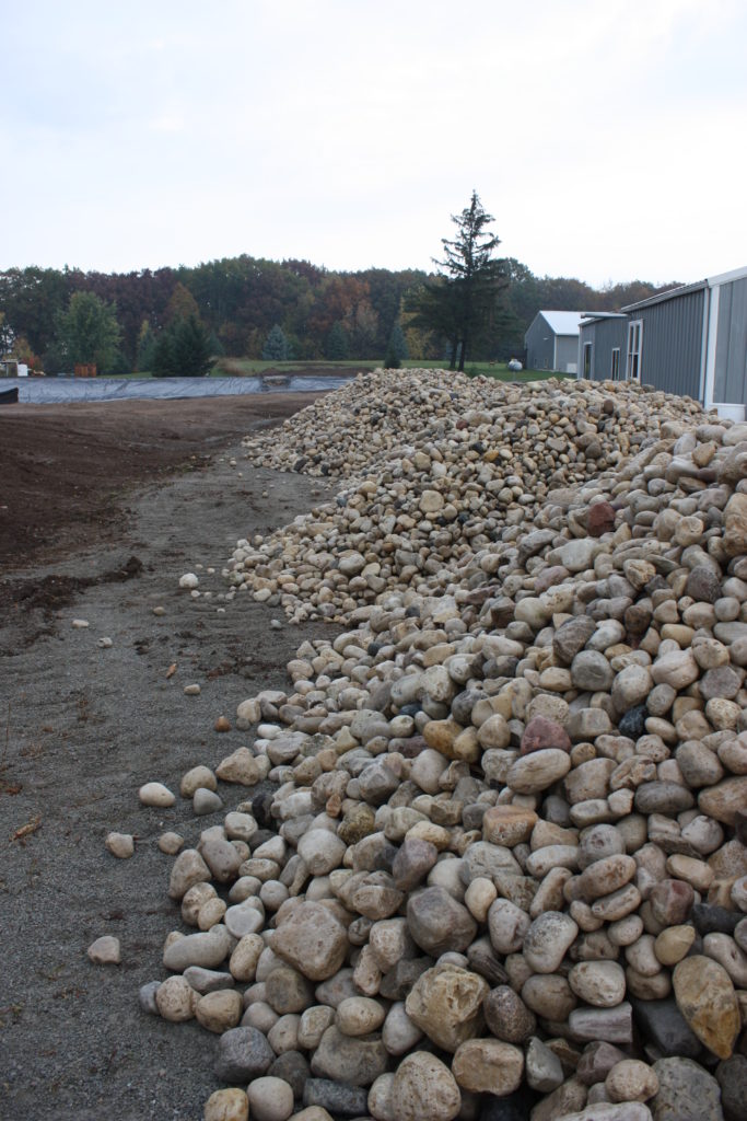 Backyard swim pond rip rap stone for shoreline