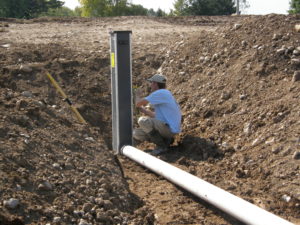 Backyard swim pond overflow valve installation